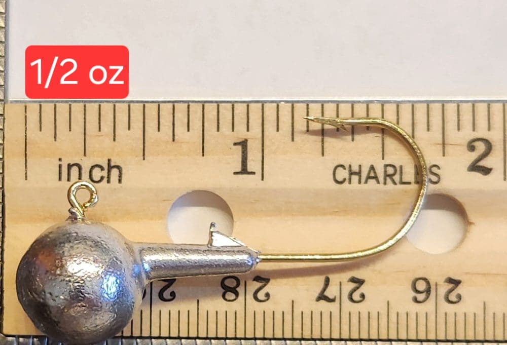 A fishing hook is shown next to a measuring tape.