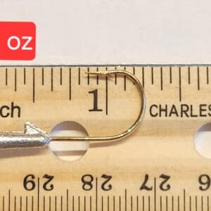 A measuring tape with a needle and thread in it.