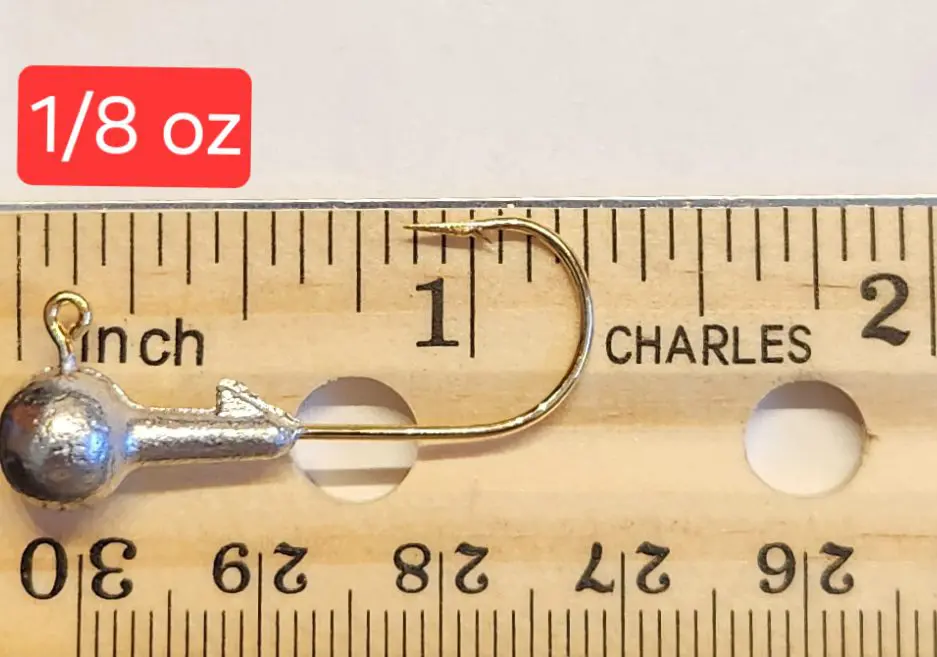 A measuring tape with a needle and thread in it.