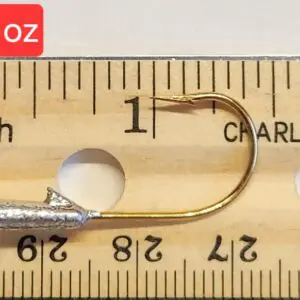 A fishing hook is measured on the ruler.