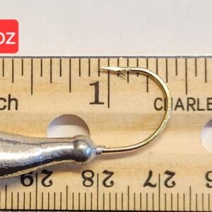 A fishing hook is shown on top of a ruler.