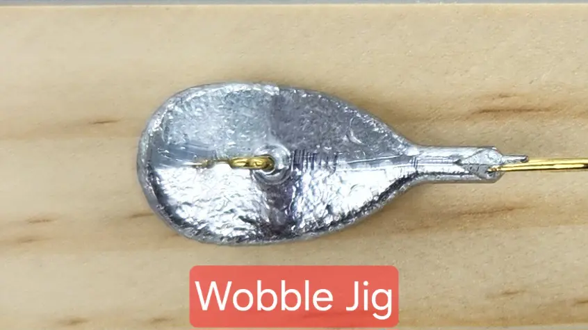 A spoon with a piece of metal on it.