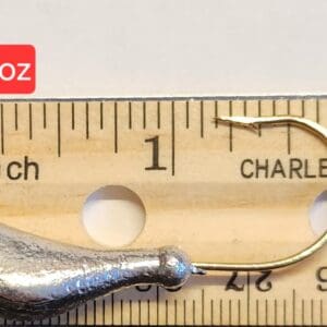 A fishing hook is shown next to a ruler.