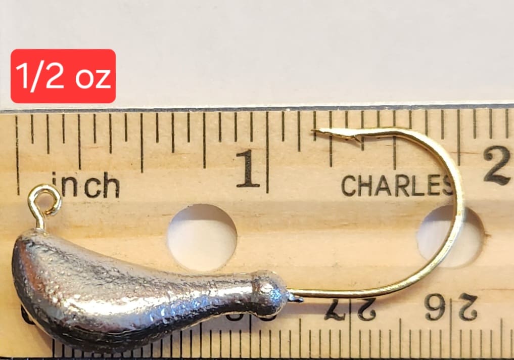 A fishing hook is shown next to a ruler.