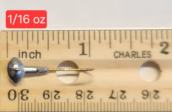 A ruler with a needle and a pencil on it.