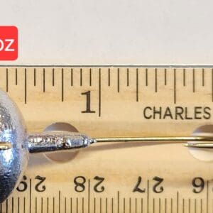 A close up of a measuring tape with a metal object