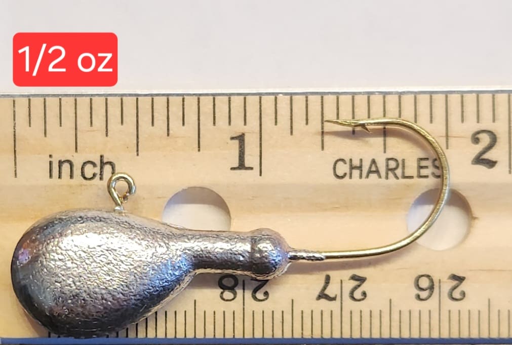 A fishing hook is shown next to a ruler.