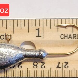 A fishing hook is shown on top of a ruler.