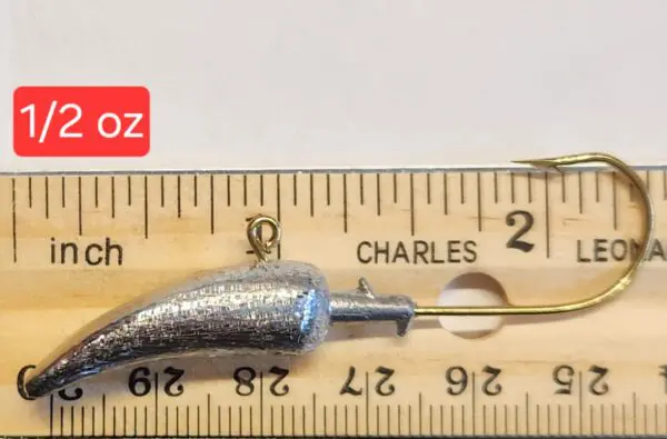 A fishing hook is shown next to a ruler.