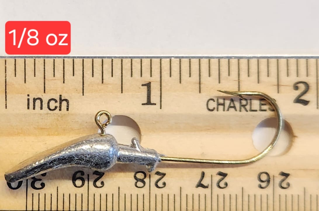 A wooden ruler with a metal fishing hook on it