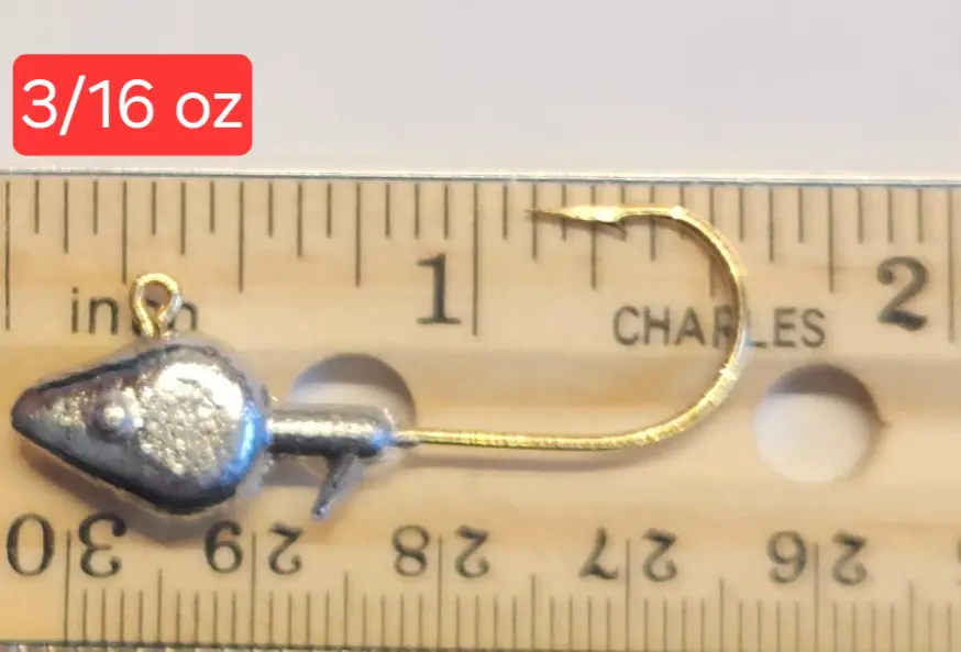 A wooden ruler with a metal hook and some gold colored wire