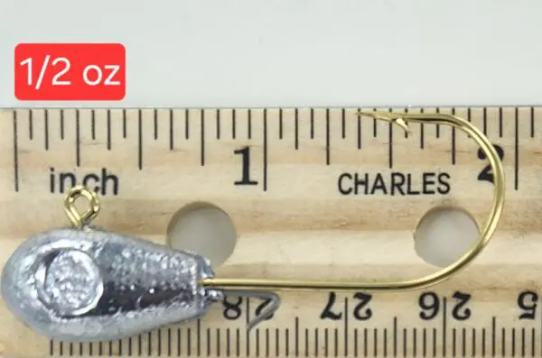 A fishing hook is shown next to a ruler.