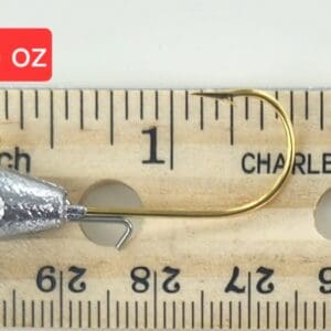 A fishing hook is shown on top of a ruler.