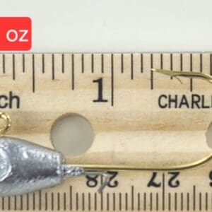 A wooden ruler with a fish hook and a measuring tape.