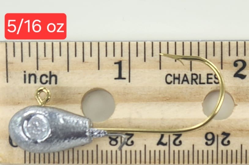 A wooden ruler with a fish hook and a measuring tape.