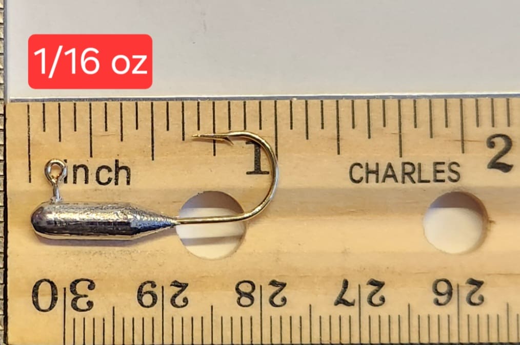 A fishing hook is measured on the ruler.