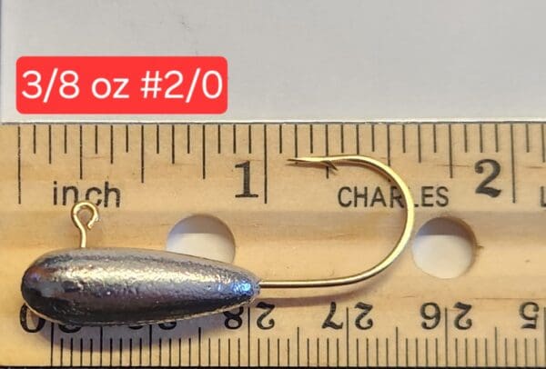 A fishing hook is shown next to a ruler.