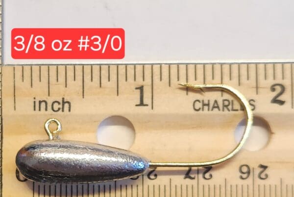 A fishing hook is shown next to a ruler.