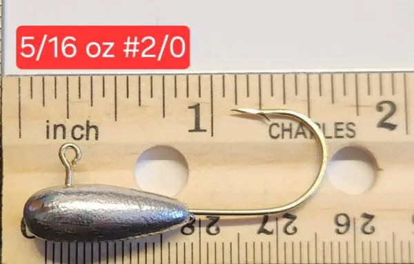 A fishing hook is shown next to a ruler.