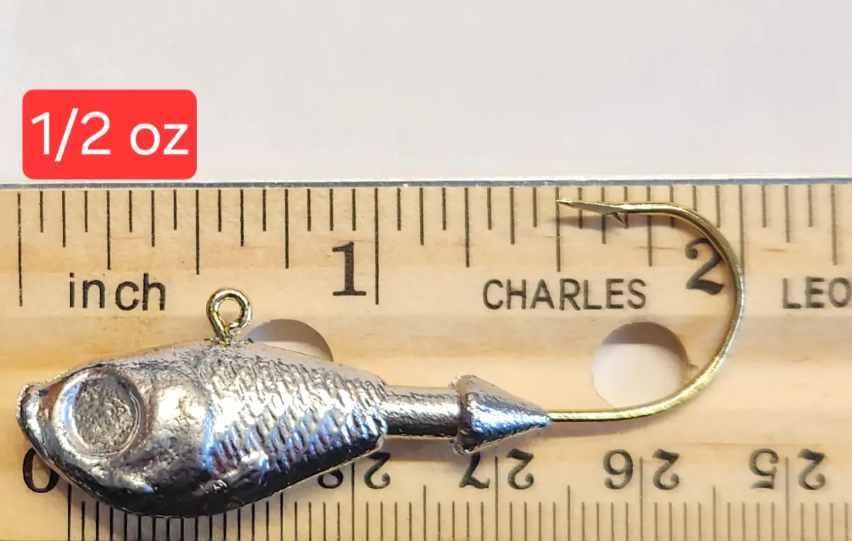 A fishing hook is shown next to a ruler.