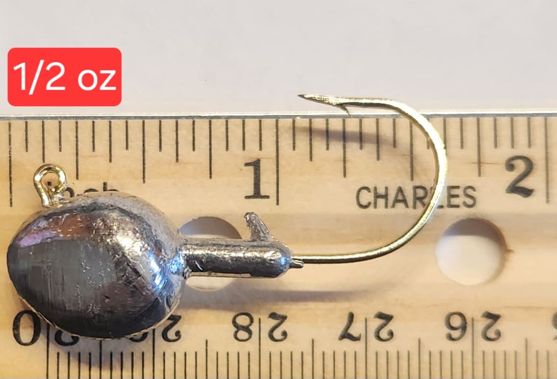 A close up of a fishing hook on a ruler