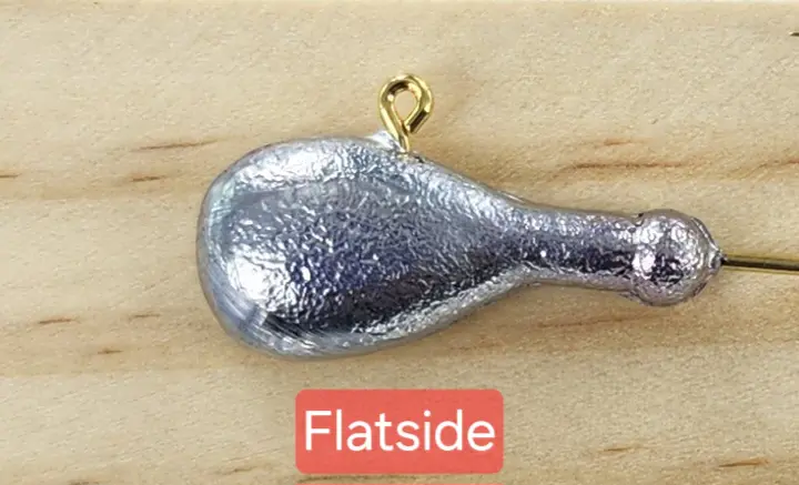 A close up of the bottom end of a silver spoon