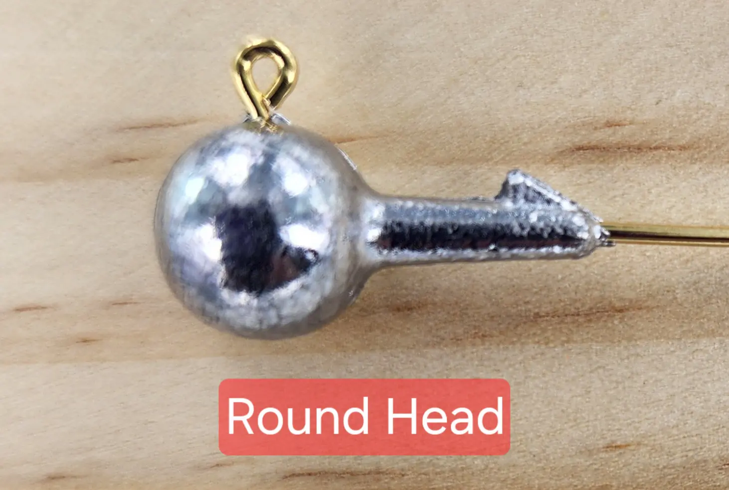 A close up of the round head on a fishing hook